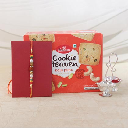 Sandalwood rakhi with a book and cookies