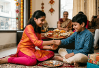 A sister tying a traditional Rakhi on her brother's wrist