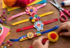 Kids making colorful handmade DIY Rakhi using paper, buttons, ribbons and wool.